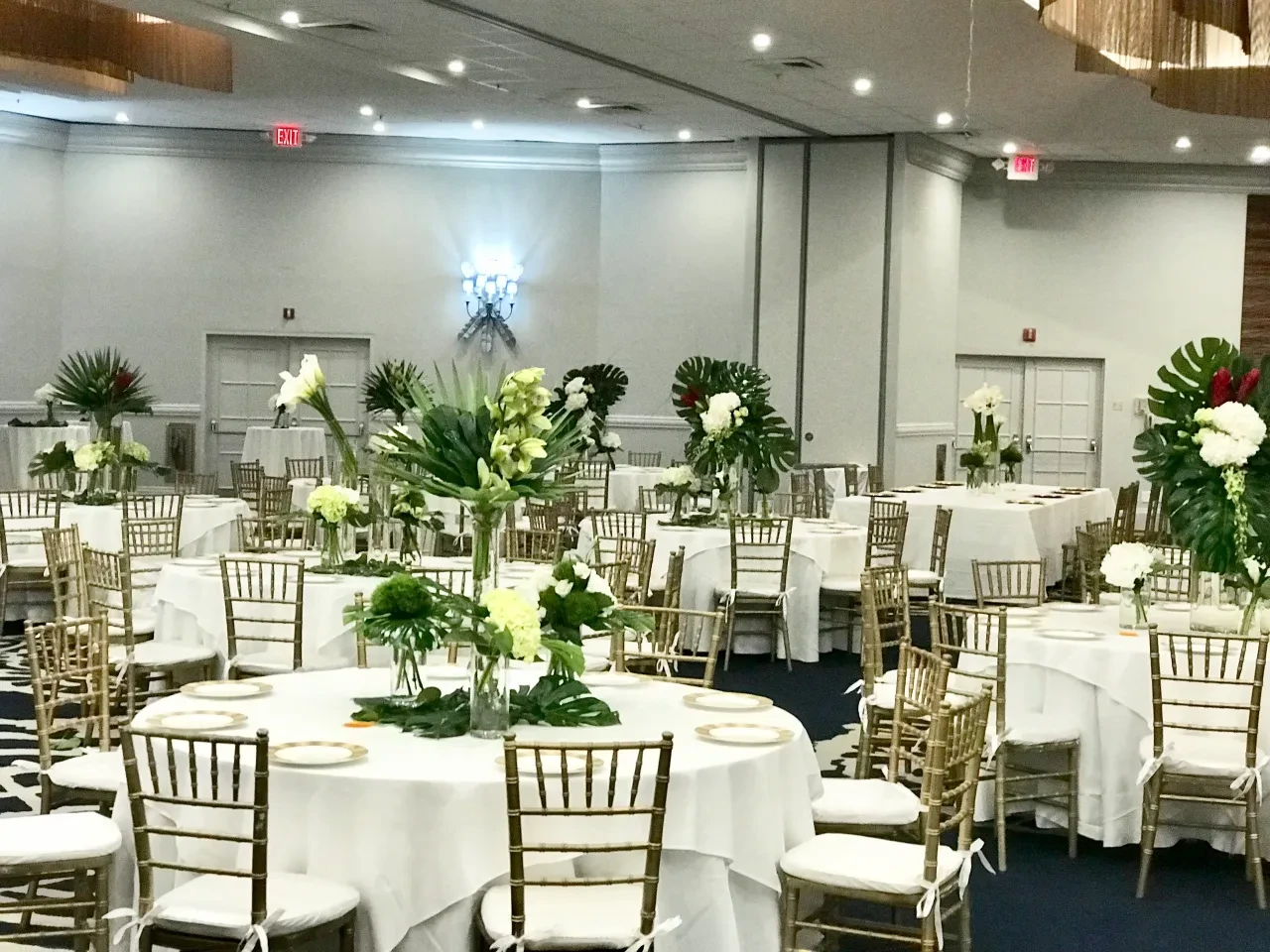Ballroom tables with tall tropical floral arrangements