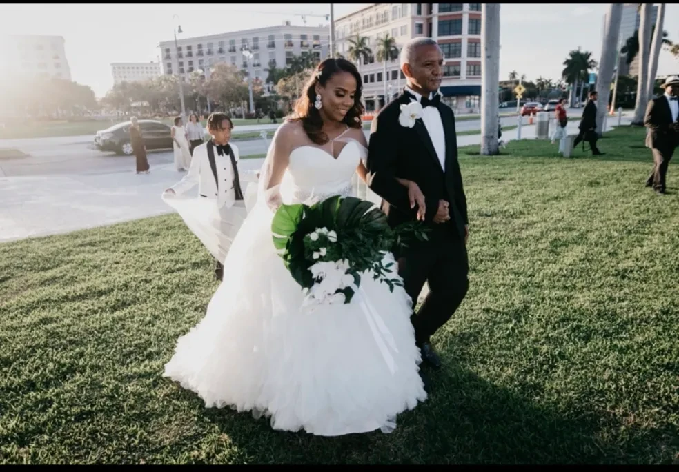Bride walking with escort in outdoor garden setting