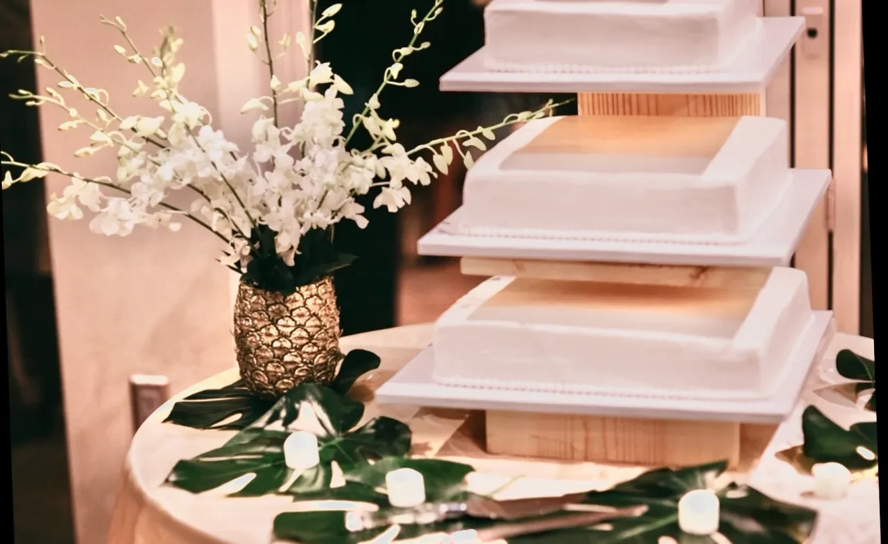 Elegant wedding table with white orchids and monstera leaves