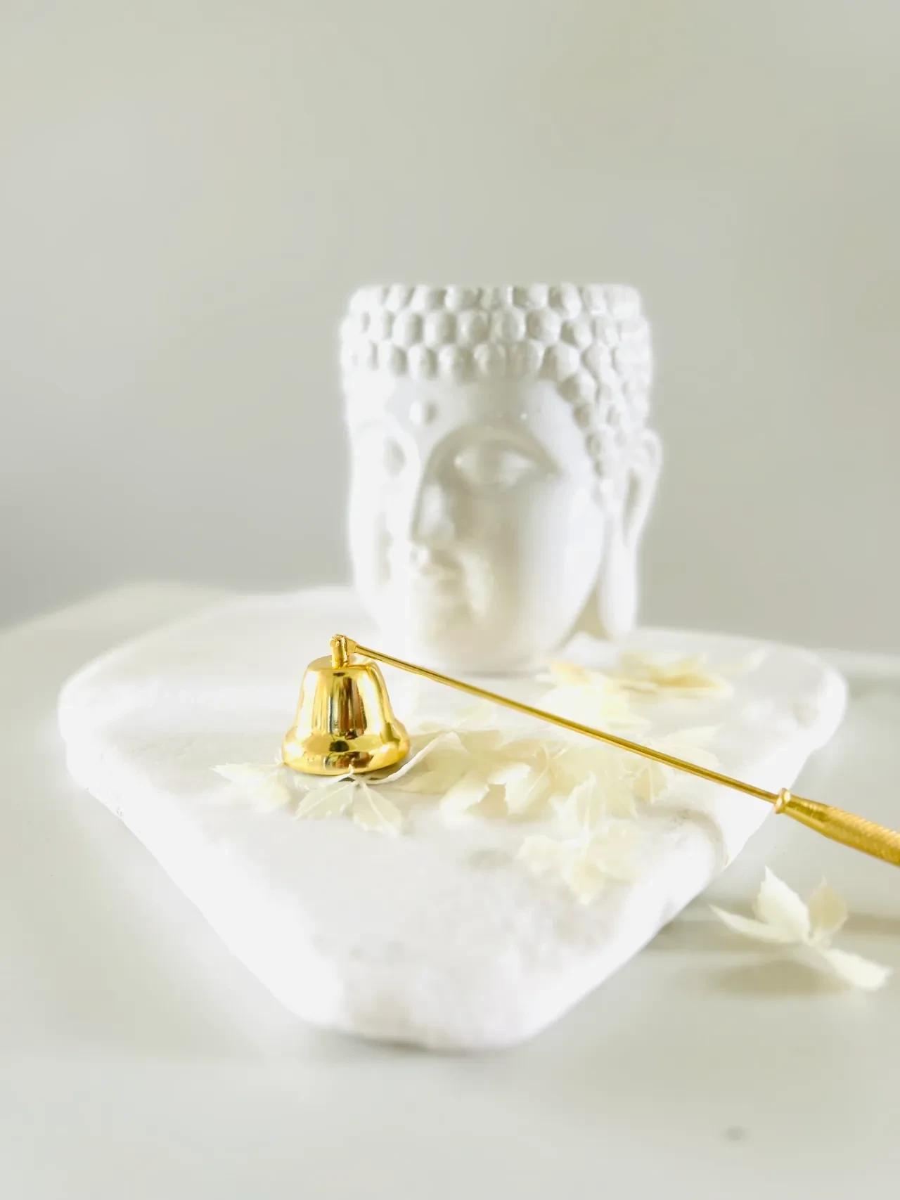 Gold bell wand with white classical sculpture display